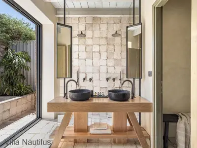 a bathroom with two sinks on a wooden table at Elafonisi Villas in Livadia
