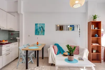 a living room with a table and a couch at Backyard Art Studio in Chania Town