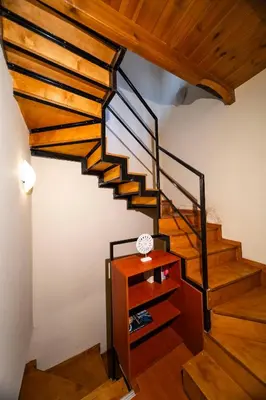 a staircase in a house with a wooden ceiling at Casa Stella in Chania Town