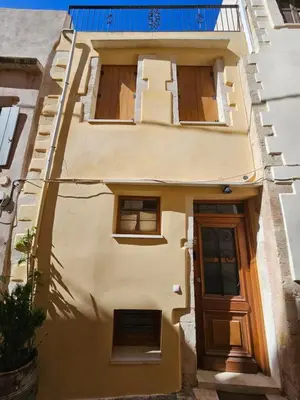 a yellow house with a door and windows at Casa Stella in Chania Town