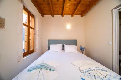 a bedroom with a bed with white sheets and pillows at Casa Stella in Chania Town