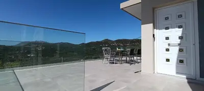a balcony with a glass door and a table with chairs at Christos in Kissamos