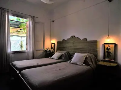 a bedroom with two beds and a window at Η αυλή της Ασπασίας, Χανιά Κρήτη in Lákkoi