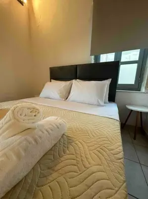 a bedroom with a bed with a blanket on it at Casa Di Sarpaki in Chania Town