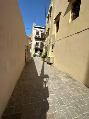 a shadow of a person walking down a street at Casa Di Sarpaki in Chania Town