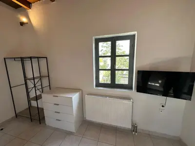 a white room with a window and a tv on the wall at Casa Di Sarpaki in Chania Town