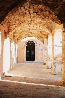 a hallway with a black door in a building at Roussos Place - Next To Splantzia Square - 2bd 2ba in Chania Town