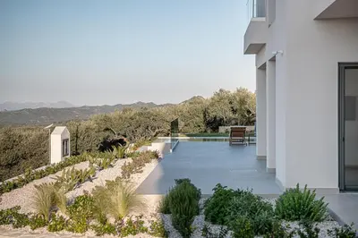 a house with a view of a garden at Villa Levante With Sea View in Plataniás