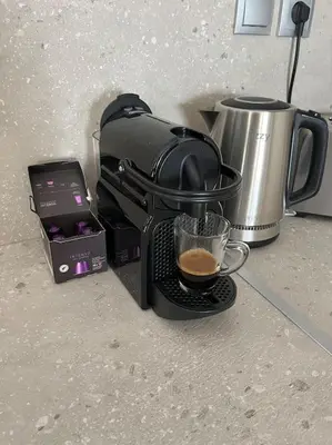 a coffee maker on a counter with a cup of coffee at Ion villa - Xirokampi in Ayiá