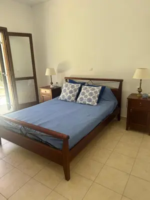 a bedroom with a bed with two pillows on it at Villa Europa Ravdoucha Private Pool and Amazing View in Ravdhoúkha