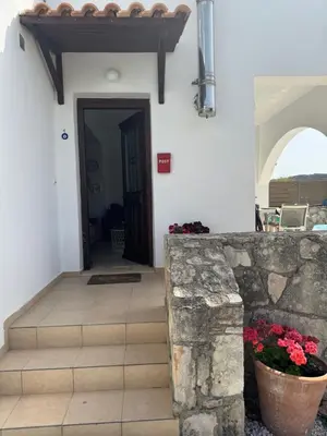 a hallway of a house with a door and flowers at Villa Europa Ravdoucha Private Pool and Amazing View in Ravdhoúkha