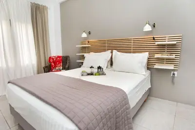 a bedroom with a large bed with a wooden headboard at Modern House in the Old Town in Chania Town