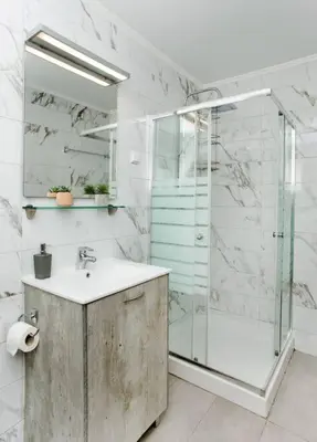 a bathroom with a sink and a glass shower at Modern House in the Old Town in Chania Town