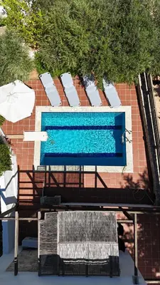 an overhead view of a swimming pool with two benches at Villa Olivia in Chania Town