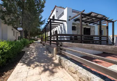a sidewalk next to a building with a wooden fence at Villa Olivia in Chania Town