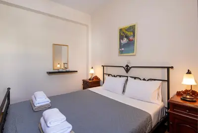 a bedroom with a bed with two towels on it at Villa Olivia in Chania Town