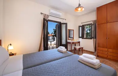 a bedroom with a blue bed with towels on it at Villa Olivia in Chania Town