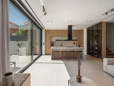 a kitchen and living room with sliding glass doors at Sancy Luxury Villa I 400m beach, 