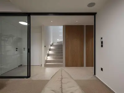 a hallway with a sliding glass door and stairs at Sancy Luxury Villa I 400m beach, 
