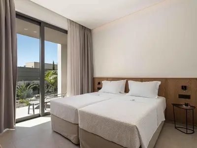 a bedroom with a white bed and a large window at Sancy Luxury Villa I 400m beach, 