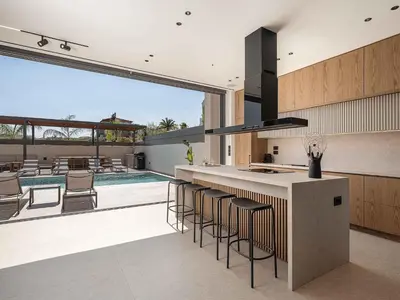 a kitchen with a bar and a swimming pool at Sancy Luxury Villa I 400m beach, 