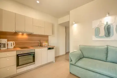 a living room with a couch and a kitchen at Koutris Apartment 1 in Falasarna