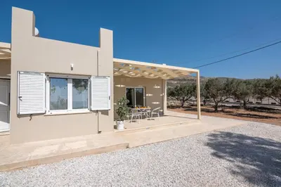 a white house with a patio in front of it at Koutris Apartment 1 in Falasarna