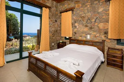 a bedroom with a bed and a large window at Amazing sea views at villa Elafonissi with private pool, near Elafonissi beach in Chania Town