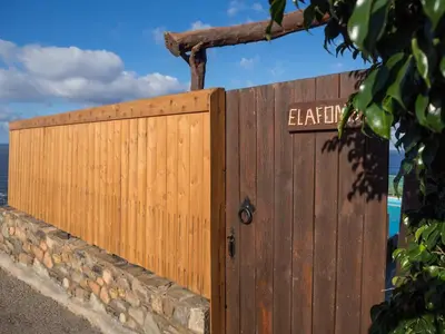 a wooden gate with a sign on it at Amazing sea views at villa Elafonissi with private pool, near Elafonissi beach in Chania Town