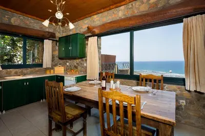 a dining room with a table and a view of the ocean at Amazing sea views at villa Elafonissi with private pool, near Elafonissi beach in Chania Town
