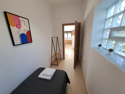 a small room with a bed and a window at Olea Homes in Plátanos