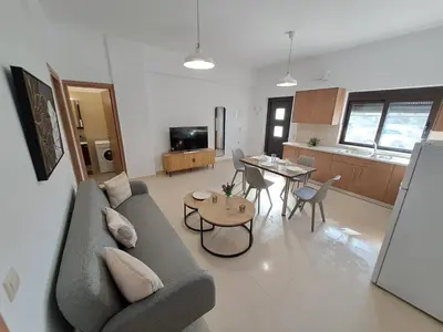 a living room with a couch and a table at Olea Homes in Plátanos
