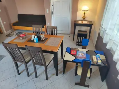 a dining room with a table and chairs at Rododafni Apartments in Kolymvari
