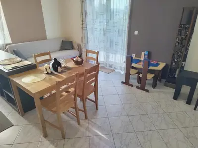 a living room with a table and chairs and a couch at Rododafni Apartments in Kolymvari