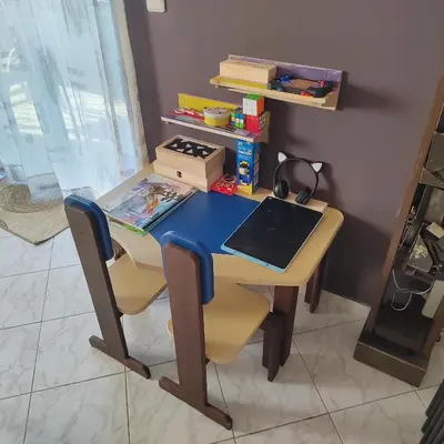 a desk with a laptop and two chairs at Rododafni Apartments in Kolymvari