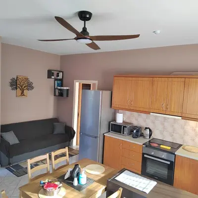 a kitchen with a couch and a table in a kitchen at Rododafni Apartments in Kolymvari