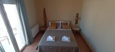 a bedroom with a bed with two pillows on it at Casa Lazareta in Chania Town