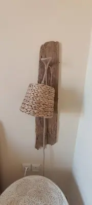 a basket hanging on a wall next to a bed at Casa Lazareta in Chania Town