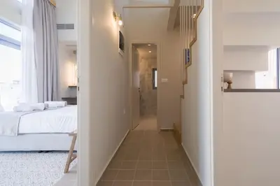 a hallway leading to a bedroom with a bed at Once Upon a Home in Chania Town