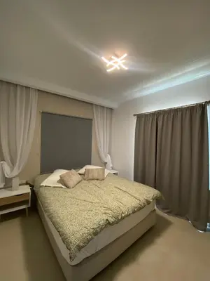 a bedroom with a large bed with a light on the ceiling at Άγιος Ιωάννης in Chania Town