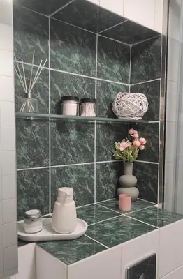 a green tiled wall with vases and flowers on a counter at Άγιος Ιωάννης in Chania Town