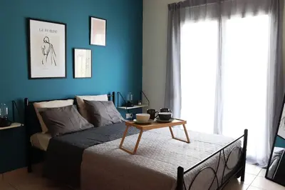 a bedroom with a bed with a table on it at Down Town apartment 27a in Chania Town