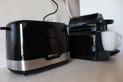 a black toaster and a coffee maker on a counter at Down Town apartment 27a in Chania Town