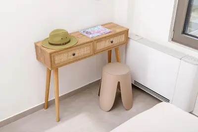 a small wooden table with a hat on top of it at Penny's Apartment in Chania Town