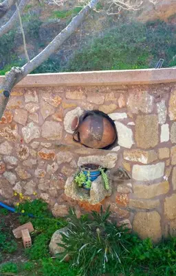 a stone wall with a statue on it at Chania Paradise Retreat in Rodhopós