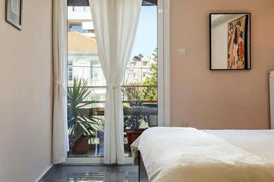 a bedroom with a bed and a large window at Modern & Spacious Flat - Chania Center - Walk To Sea in Chania Town