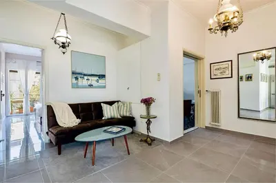 a living room with a couch and a table at Modern & Spacious Flat - Chania Center - Walk To Sea in Chania Town