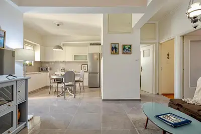 a kitchen and living room with a couch and a table at Modern & Spacious Flat - Chania Center - Walk To Sea in Chania Town