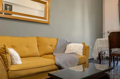 a living room with a couch and a table at Modern & Spacious Flat - Chania Center - Walk To Sea in Chania Town