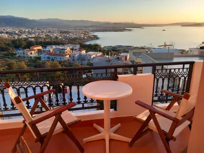 a table and two chairs on a balcony with a view at Villa Nancy in Chania Town